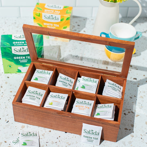 Salada tea chest, lid open and looking down on the tea envelopes inside